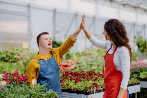 image of a woman florist helping young employee