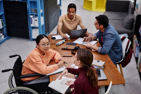 Teenage girl with disability talking to friend, Photos - Envato Elements