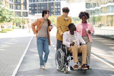 People walking with friend with disability, Photos - Envato Elements