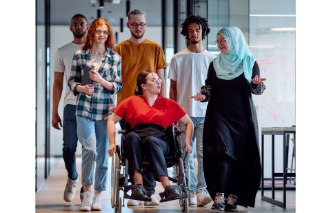 image of A diverse group of young business people walking a corridor in the glass-enclosed office of a modern, Photos - Envato Elements