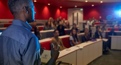 man lecturing students university lecture